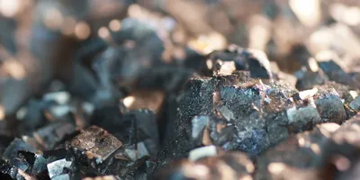 Close-up of a mineral matrix with sharp-edged crystals, illustrating the type of complex solid sample that can be analyzed using dual-laser mass spectrometry.