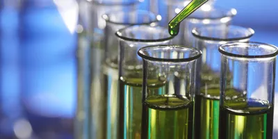 Biomarker testing concept illustrated with a test tube and dropper, representing fluid sample analysis in proteomics workflows.
