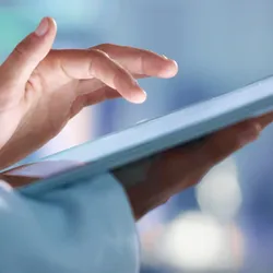 Doctor, researcher or scientist browsing the internet on a tablet for information while working at a lab, science facility or hospital. Expert, medical professional or surgeon searching the internet


