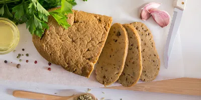 Sliced seitan, a plant-based protein source, displayed with spices, representing food samples analyzed using ICP-MS for trace metal testing in alternative proteins.
