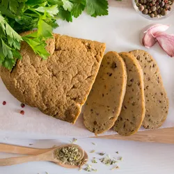 Sliced seitan, a plant-based protein source, displayed with spices, representing food samples analyzed using ICP-MS for trace metal testing in alternative proteins.