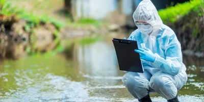 Ecologist in protective clothing collecting water samples from a lake, alongside laboratory equipment imagery, representing both field sampling and lab analysis for environmental and food safety testing of microplastics, PFAS, and other contaminants.