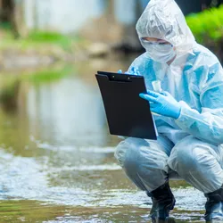 Ecologist in protective clothing collecting water samples from a lake, alongside laboratory equipment imagery, representing both field sampling and lab analysis for environmental and food safety testing of microplastics, PFAS, and other contaminants.