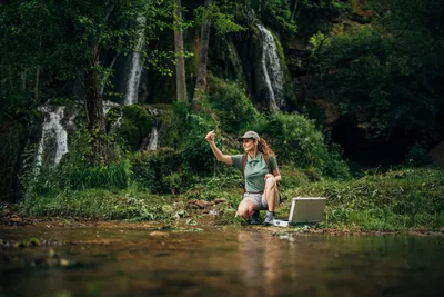 Environmental scientist collecting a water sample from a natural environment, symbolizing PFAS monitoring and environmental analysis.