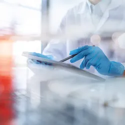 Laboratory technician analyzing airflow paths with a tablet