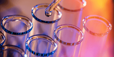  Test tube row. Concept of medical or science laboratory, liquid drop droplet with dropper in blue red tone background.