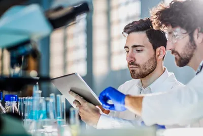 Researchers using compound inventory management software in a lab