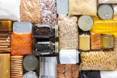 Diverse food ingredients arranged neatly in containers and bags.