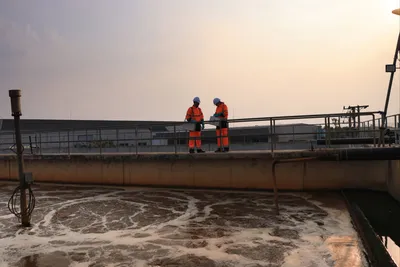 Workers analyzing PFAS removal strategies at a wastewater treatment plant