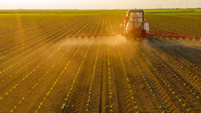 Tractor applying biocontrol agents in sustainable agriculture