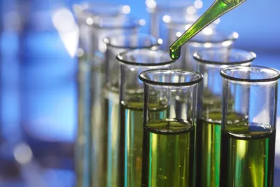 Green analytical chemistry depicted with vibrant liquids in test tubes