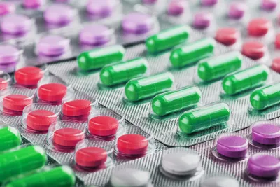 Colorful capsules and tablets in packaging for extractables and leachables testing