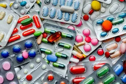 Various capsules and tablets in blister packs for drug discovery.