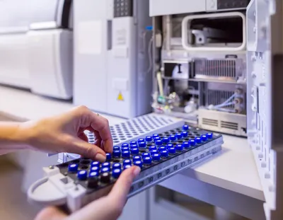 Analyst preparing samples for LC/MS workflows to enhance accuracy