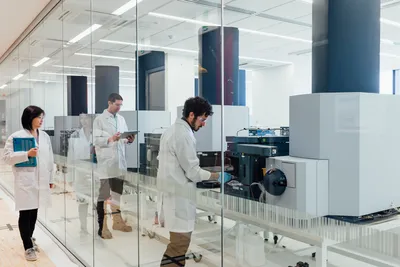Scientists using a benchtop high-resolution mass spectrometer in a lab