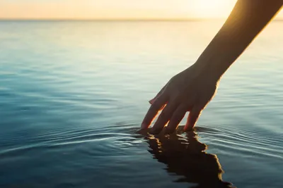Hand touching water, symbolizing PFAS testing methods