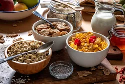 Bowl of cereals with chia seeds and fruit on a table representing furan and alkylfurans analysis.