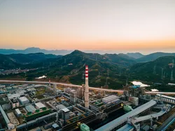 Industrial landscape with fuel processing plant and mountainous background