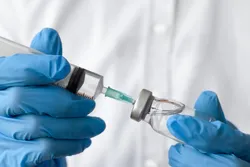 A healthcare professional preparing a self-amplifying RNA vaccine