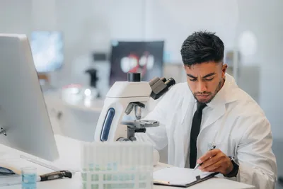 Laboratory researcher conducting microscopic characterization techniques.