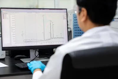 Laboratory technician examining analytical results from gas chromatography.