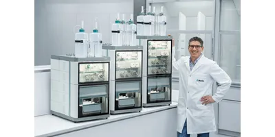 A Metrohm scientist in a white lab coat stands beside three OMNIS IC ion chromatography system configurations in a modern laboratory, demonstrating the modular scalability of the ion chromatography platform.
