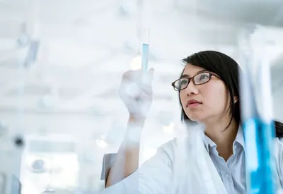 Scientist analyzing PFAS quality control samples in a lab