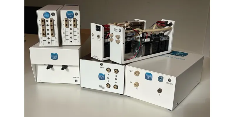 Multiple white HPLC degasser units from the Biotech Fluidics DEGASi® NG family arranged on a bench, showing channel ports, status indicators, and DVC vacuum controller modules.