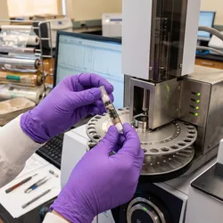 Laboratory technician preparing a sample for thermal desorption gas chromatography