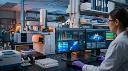 Scientist analyzing chromatographic data with AI tools in a lab setting.